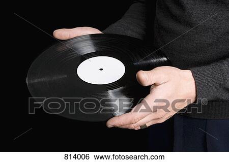A man holding a record View Large Photo Image Stock Photograph - A man holding a record. Fotosearch