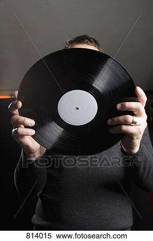 A man holding a record View Large Photo Image Stock Photography - A man holding a record. Fotosearch