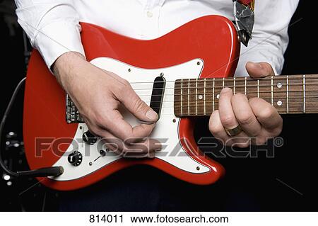 Detail of a man playing an electric guitar View Large Photo Image Stock Image - Detail of a man playing an electric guitar. Fotosearch