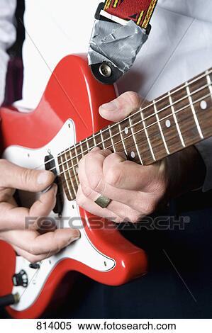 Detail of a man playing an electric guitar View Large Photo Image Stock Photography - Detail of a man playing an electric guitar. Fotosearch