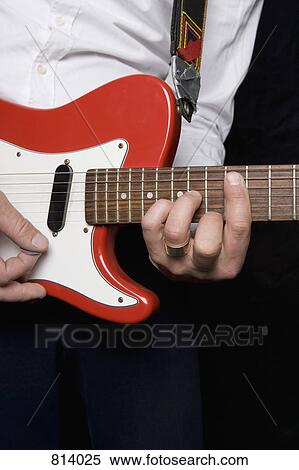 Detail of a man playing an electric guitar View Large Photo Image Stock Photography - Detail of a man playing an electric guitar. Fotosearch