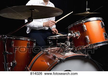 Stock Photograph - Detail of a man playing drums. Fotosearch