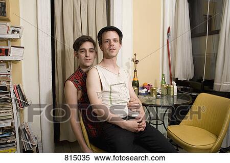 A young couple sitting together by a table View Large Photo Image Stock Photography - A young couple sitting together by a table. Fotosearch