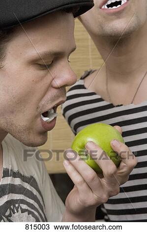 Two young men wearing plastic vampire teeth View Large Photo Image Stock Image - Two young men wearing plastic vampire teeth. Fotosearch