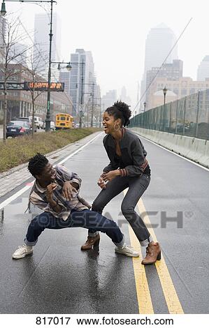 A young couple play fighting on a street, Manhattan, New York City View Large Photo Image Stock Photo - A young couple play fighting on a street, Manhattan, New York City. Fotosearch