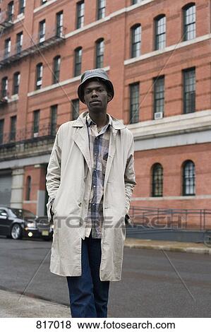 Portrait of a young man standing on a sidewalk View Large Photo Image Stock Photo - Portrait of a young man standing on a sidewalk. Fotosearch