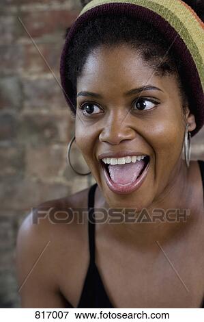 Portrait of a young woman with her mouth open View Large Photo Image Stock Photo - Portrait of a young woman with her mouth open. Fotosearch