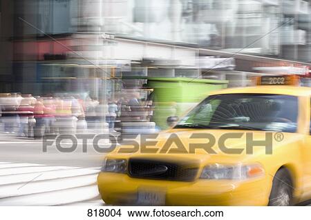 Picture - A yellow taxi on a city street, Manhattan, New York City. Fotosearch