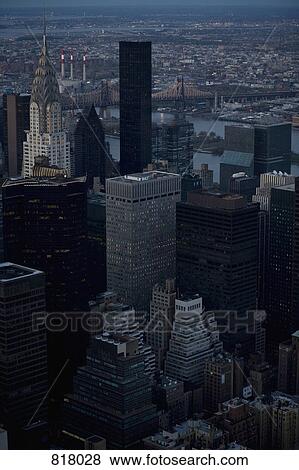 Stock Photo - The Chrysler Building and the Brooklyn Bridge in the cityscape at sunset, Manhattan, New York City . Fotosearch