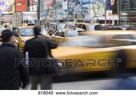 Yellow taxi's and pedestrians on a city street, Manhattan, New York City View Large Photo Image Stock Photo - Yellow taxi's and pedestrians on a city street, Manhattan, New York City. Fotosearch