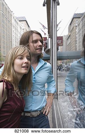A young couple looking in a shop window, New York City View Large Photo Image Stock Photo - A young couple looking in a shop window, New York City. Fotosearch