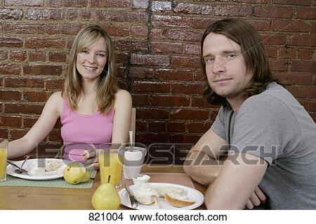 Portrait of a young couple having breakfast together View Large Photo Image Picture - Portrait of a young couple having breakfast together. Fotosearch