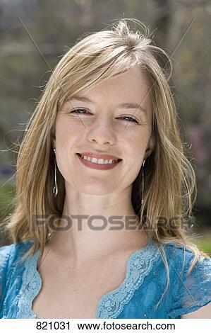 Stock Image - Portrait of a young woman smiling. Fotosearch