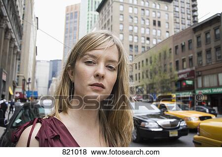 Portrait of a young woman standing on a city street, New York City View Large Photo Image Stock Photo - Portrait of a young woman standing on a city street, New York City. Fotosearch
