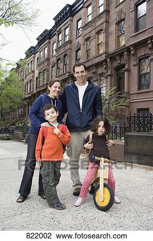 A family standing in front of a row of brownstone townhouses, Brooklyn, New York City View Large Photo Image Stock Image - A family standing in front of a row of brownstone townhouses, Brooklyn, New York City. Fotosearch
