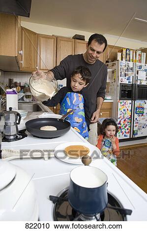A father and his children making pancakes together View Large Photo Image Stock Image - A father and his children making pancakes together. Fotosearch