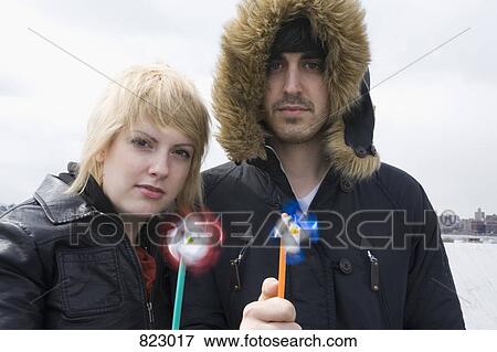 A young couple holding pinwheels View Large Photo Image Stock Photo - A young couple holding pinwheels. Fotosearch