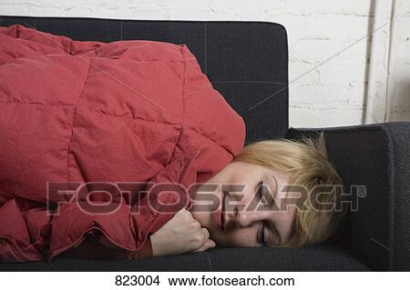 A young woman sleeping on a sofa View Large Photo Image Picture - A young woman sleeping on a sofa. Fotosearch