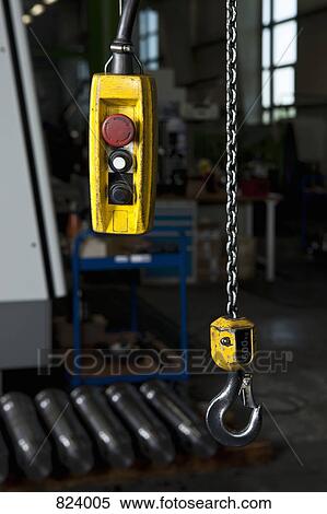 A chain hoist and its control in a metal parts factory View Large Photo Image Stock Photography - A chain hoist and its control in a metal parts factory. Fotosearch