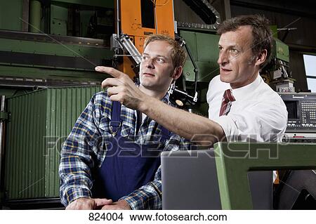 A factory manager and a factory worker View Large Photo Image Picture - A factory manager and a factory worker. Fotosearch
