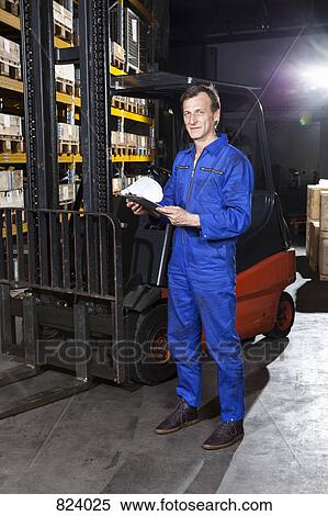 A manual worker holding a checklist in a metal parts warehouse View Large Photo Image Stock Photography - A manual worker holding a checklist in a metal parts warehouse. Fotosearch