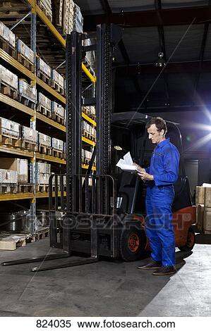 A manual worker looking at a checklist in a metal parts warehouse View Large Photo Image Stock Photography - A manual worker looking at a checklist in a metal parts warehouse. Fotosearch