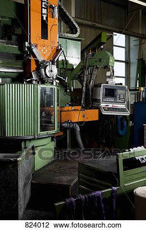 Stock Image - Manufacturing equipment at a metal parts factory. Fotosearch