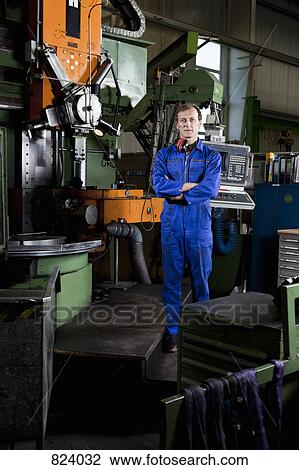 Portrait of a worker in a metal parts factory View Large Photo Image Stock Image - Portrait of a worker in a metal parts factory. Fotosearch