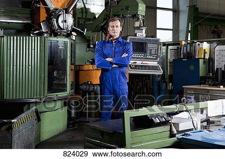 Portrait of a worker in a metal parts factory View Large Photo Image Stock Photo - Portrait of a worker in a metal parts factory. Fotosearch