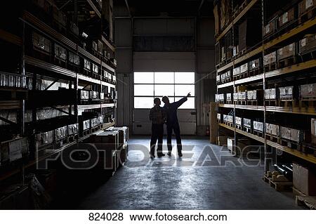Two manual workers in a metal parts warehouse View Large Photo Image Stock Photo - Two manual workers in a metal parts warehouse. Fotosearch