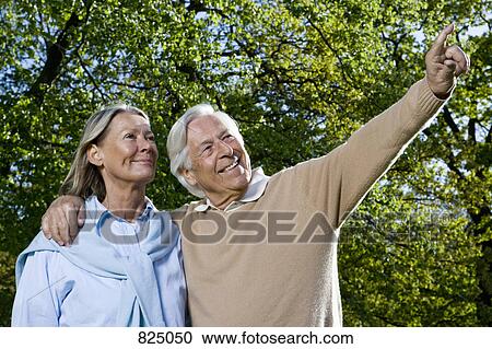 Stock Image - A senior couple looking away, outdoors. Fotosearch