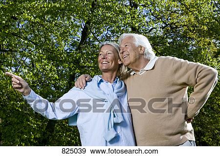 Stock Photo - A senior couple looking away, outdoors. Fotosearch