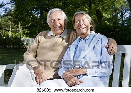 A senior couple sitting on a bench together View Large Photo Image Stock Photography - A senior couple sitting on a bench together. Fotosearch