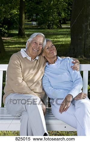 A senior couple sitting on a bench together View Large Photo Image Stock Photography - A senior couple sitting on a bench together. Fotosearch