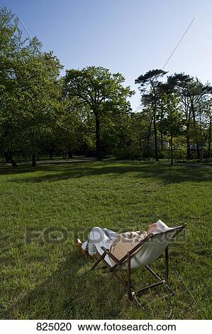 A senior man reclining in a lounge chair on a lawn View Large Photo Image Stock Image - A senior man reclining in a lounge chair on a lawn. Fotosearch