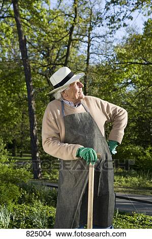 A senior man resting while doing gardening View Large Photo Image Picture - A senior man resting while doing gardening. Fotosearch