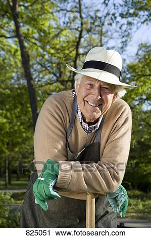 Stock Image - A senior man taking a break from gardening. Fotosearch