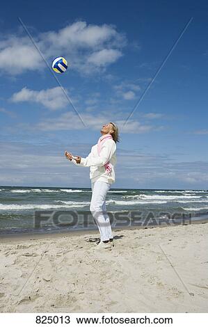 A senior woman throwing and catching a soccer ball View Large Photo Image Stock Image - A senior woman throwing and catching a soccer ball. Fotosearch
