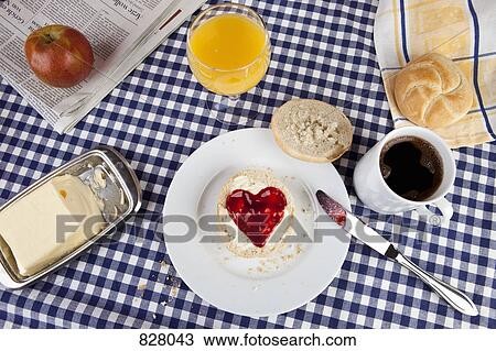 A breakfast table with a bread roll with heart shaped jam on it View Large Photo Image Stock Image - A breakfast table with a bread roll with heart shaped jam on it. Fotosearch