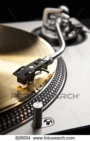 A gold record on a turntable View Large Photo Image Picture - A gold record on a turntable. Fotosearch