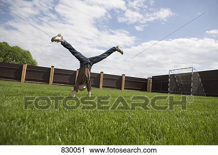 A girl doing a cartwheel View Large Photo Image Stock Image - A girl doing a cartwheel. Fotosearch