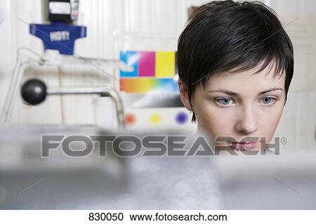 A woman working at a printers View Large Photo Image Stock Image - A woman working at a printers. Fotosearch