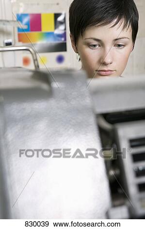 Stock Photo - A woman working at a printers. Fotosearch