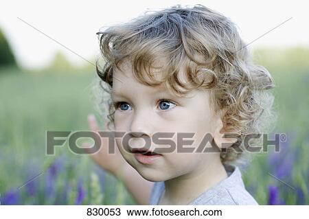 A young boy looking away and pointing View Large Photo Image Stock Image - A young boy looking away and pointing. Fotosearch