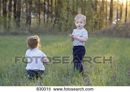 Stock Photography - A young brother and sister in a field. Fotosearch
