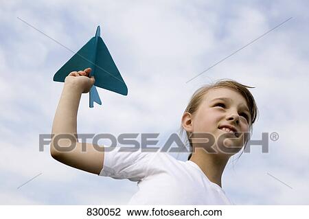 A young girl holding a model airplane View Large Photo Image Stock Image - A young girl holding a model airplane. Fotosearch