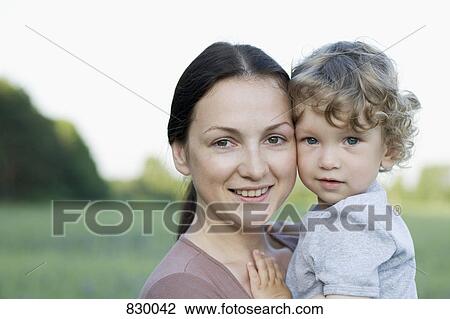Portrait of a woman and a young boy View Large Photo Image Stock Image - Portrait of a woman and a young boy. Fotosearch