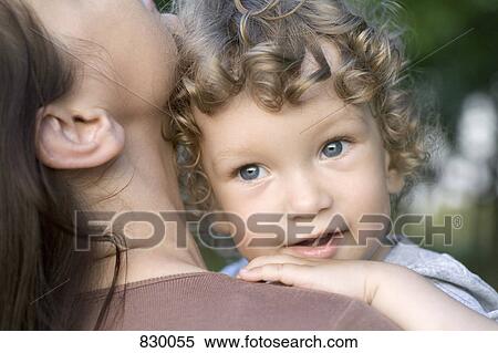 Portrait of a young boy being held by a young woman View Large Photo Image Stock Photography - Portrait of a young boy being held by a young woman. Fotosearch