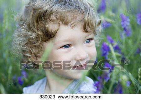 Portrait of a young boy looking away smiling View Large Photo Image Stock Photo - Portrait of a young boy looking away smiling. Fotosearch