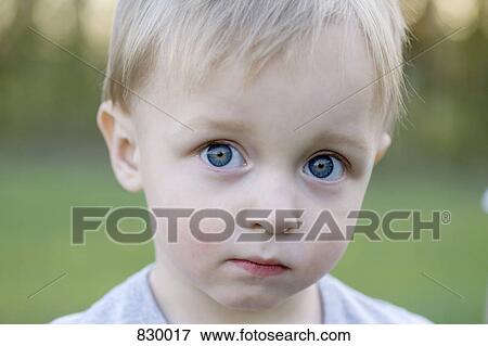 Portrait of a young boy looking sad View Large Photo Image Stock Photo - Portrait of a young boy looking sad. Fotosearch